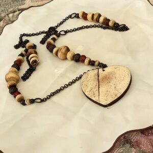 “BROKEN HEART” BONE PENDANT ON A BEADED BLACK CHAIN NECKLACE